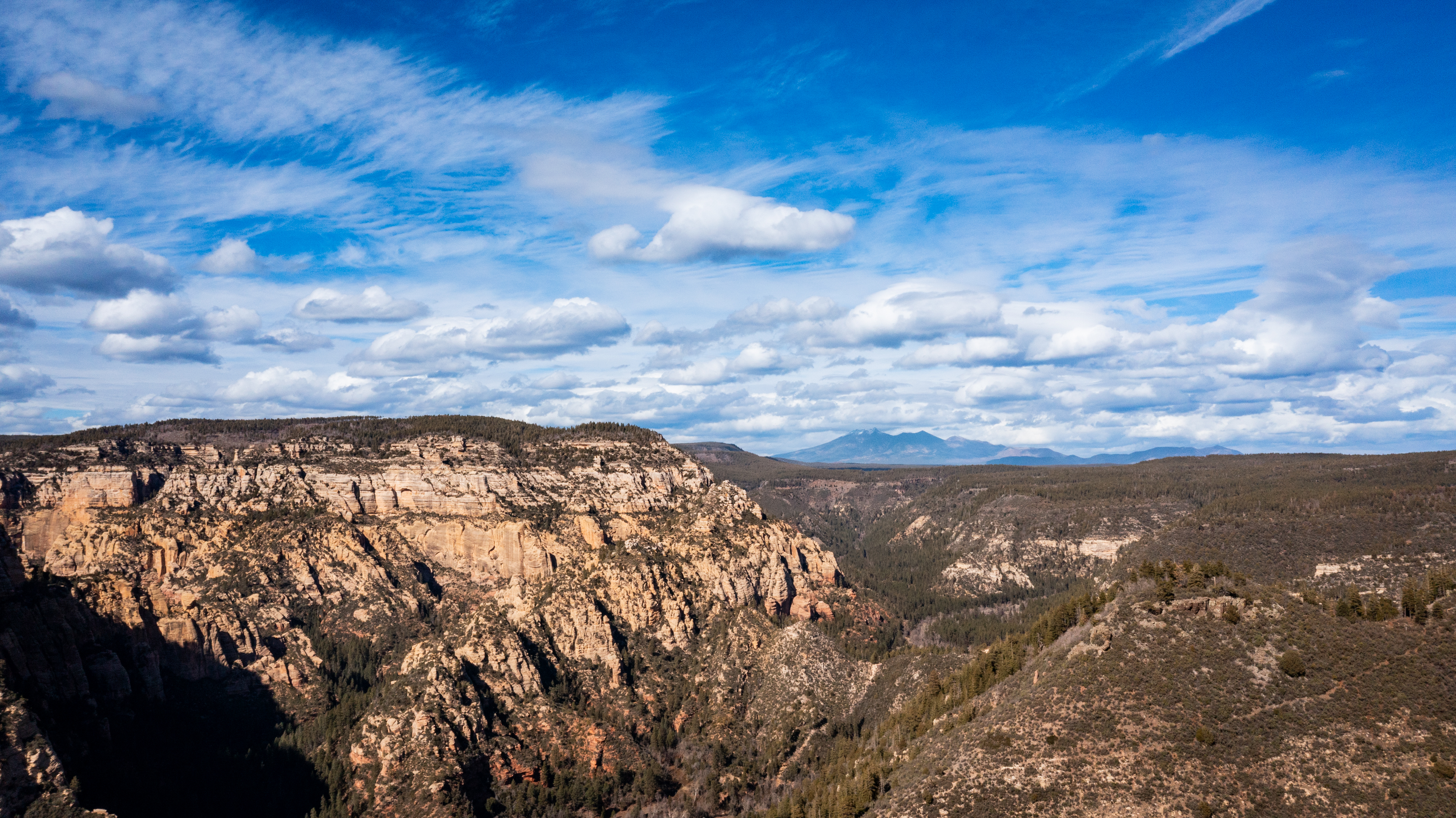 A scenic view of rocky terrain under a cloudy blue sky.
